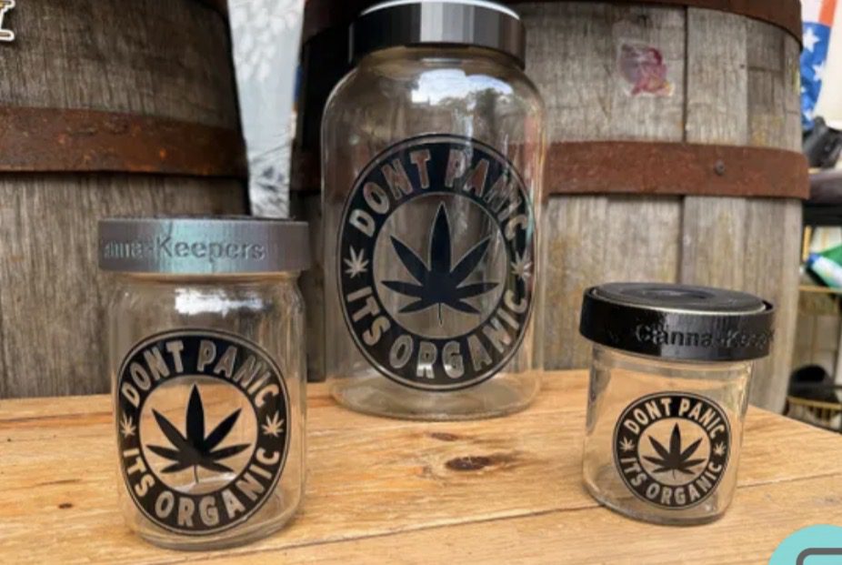 Glass cannabis storage jars labeled organic