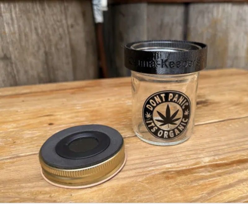 Small glass jar with cannabis leaf sticker