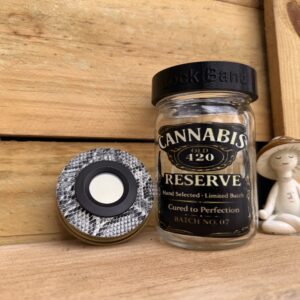 Cannabis Reserve jar with grinder and figurine