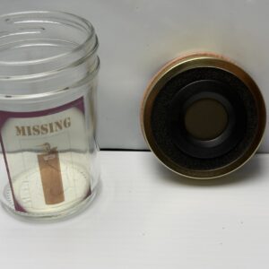 Small glass vial with a brown strip and a black and gold cap.