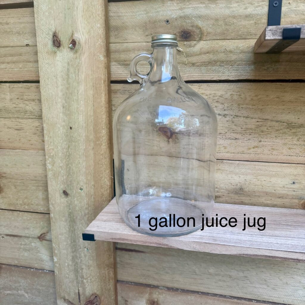 A 1-gallon juice jug placed on a wooden shelf.