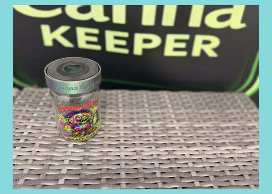 Glass Canna Keeper jar on woven table