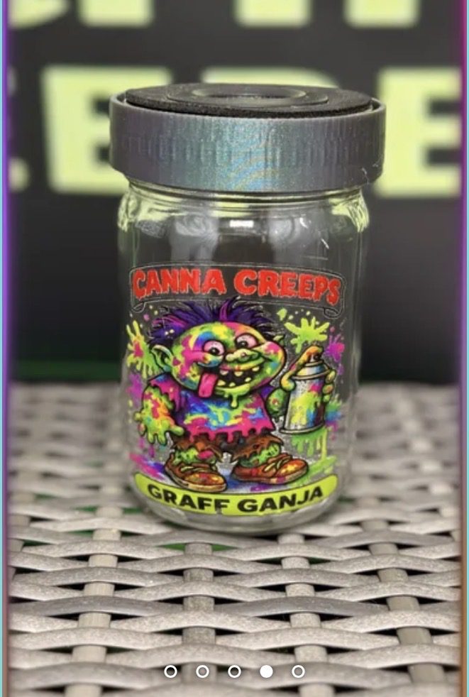 Small glass jar with colorful 'Canna Creeps' label