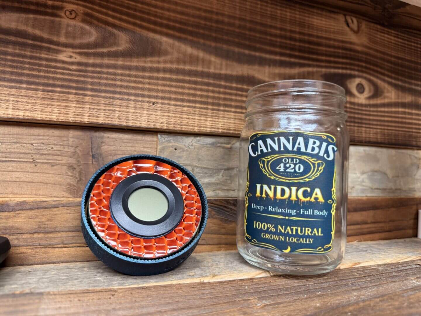 Cannabis Indica jar beside orange honeycomb speaker