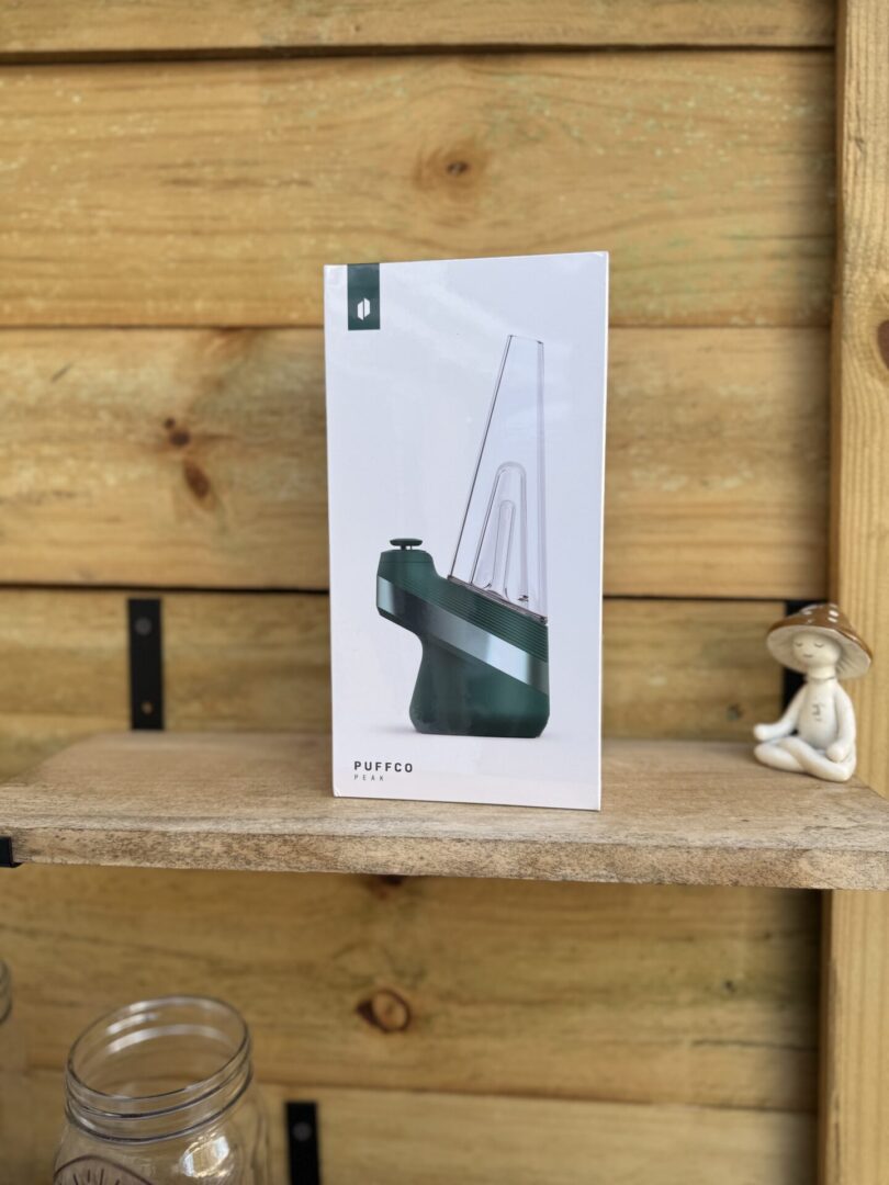 Puffco Peak box on rustic wooden shelf