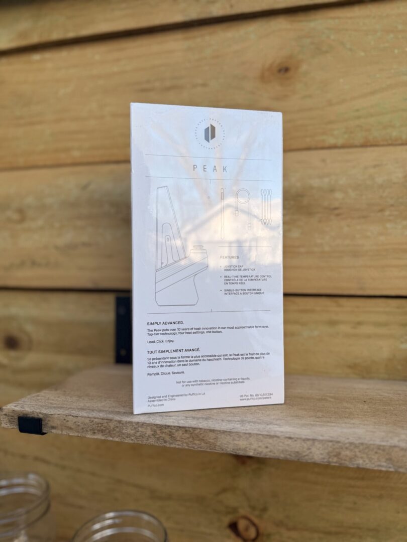 White product instruction leaflet on wooden shelf
