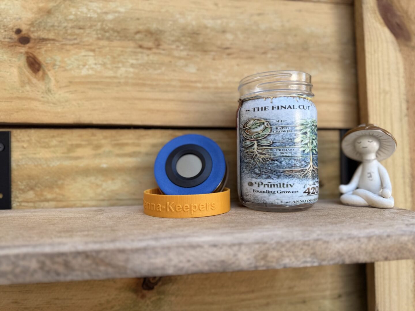 Mason jar, blue tape, meditating figurine on shelf