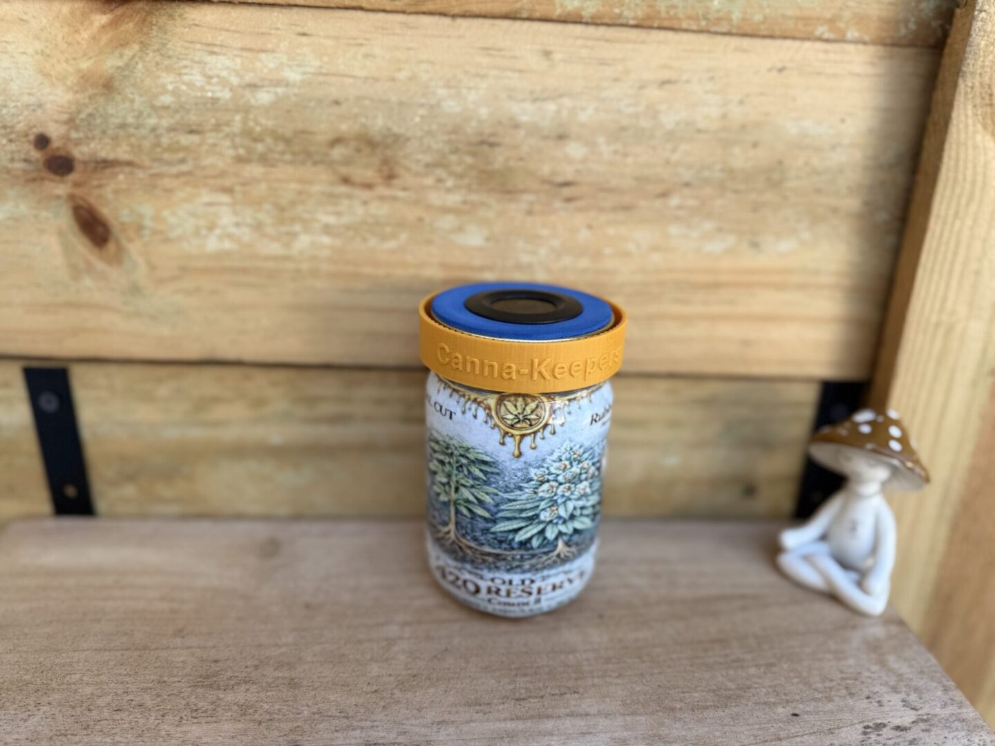 Botanical-printed jar with yellow lid on shelf